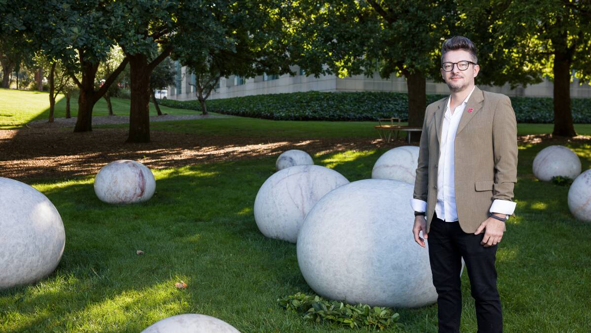Alex Seton with his sculpture Every Drop Shed in Anguish at the Sculpture Garden of the Australian War Memorial. Picture by Sitthixay Ditthavong