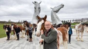 Andy Scott and Clydesdale horses in front of his famous sculpture The Kelpies in Scotland. Picture Martin Shields 