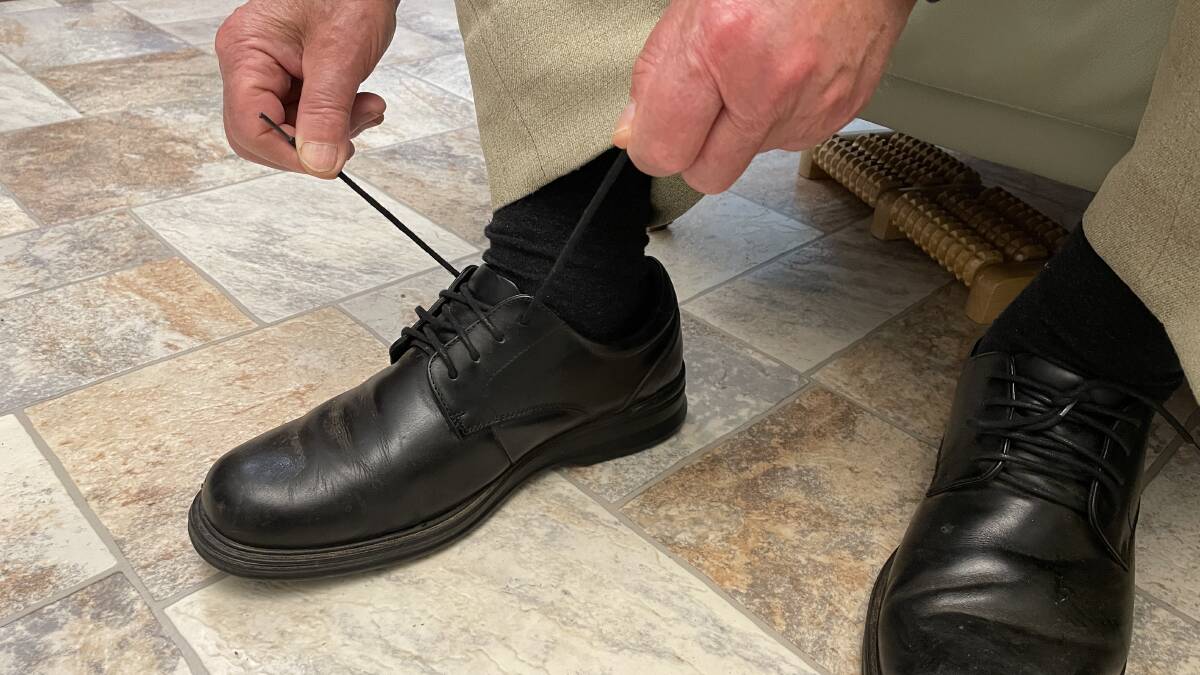 A senior tying his shoe laces. File picture