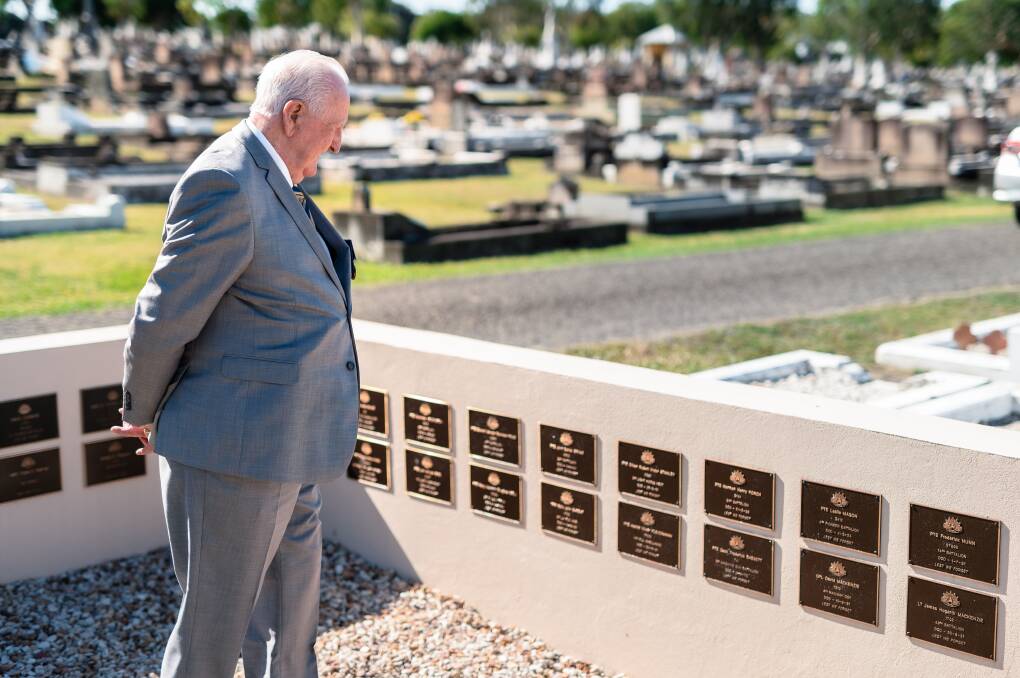 Matthew Rennie OAM observes memorial plaques at Ipswich Cemetery of those who have fallen in conflict. Picture supplied