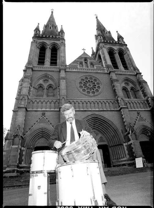 Keith Conlon plays the drums in front of St. Peter's Cathedral, North Adelaide, 1989. Picture SLSA PRG 1662/6/714/3/Vic Grimmett