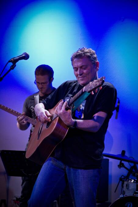 Peter Combe playing guitar on stage. Picture supplied