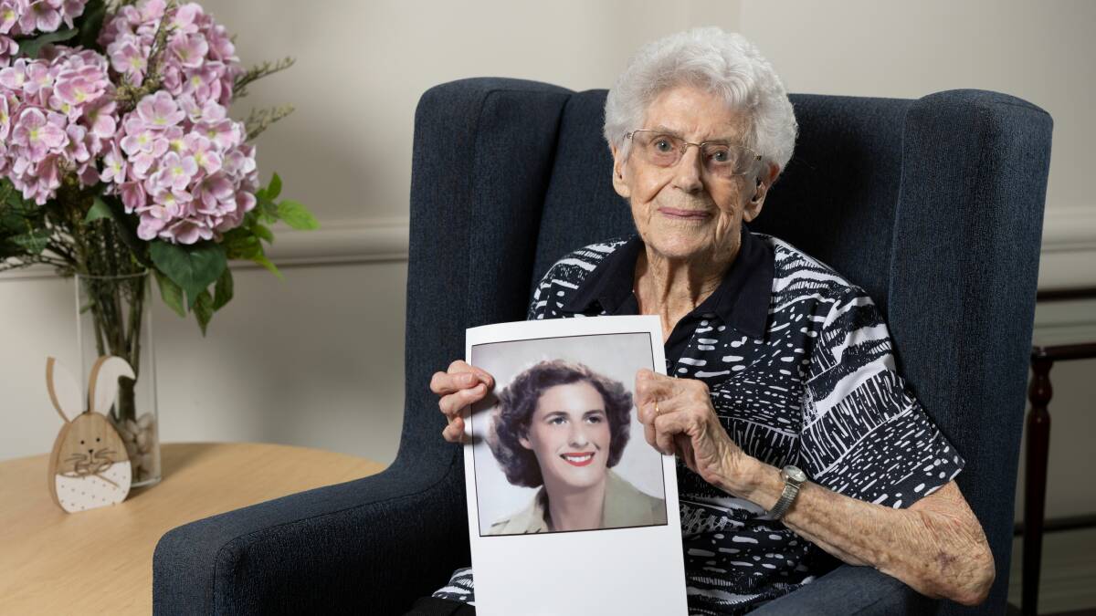 Veteran Joan Woodland with a picture of herself wearing her army uniform. Picture supplied