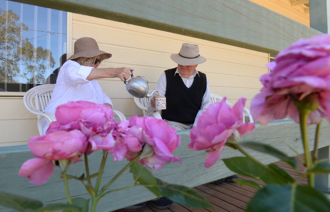Couple enjoys a humble pot of tea on their verandah. ACM file picture