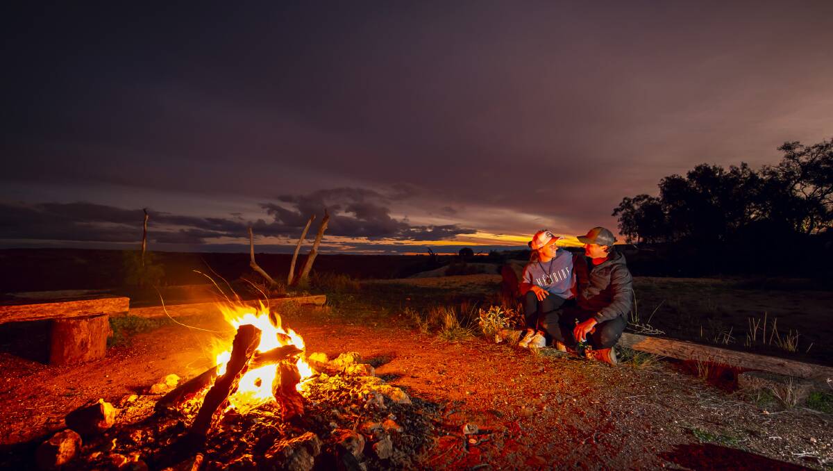 Guests enjoy the warmth of a fire on a chilly night. Picture supplied by Out of the Ordinary Outback