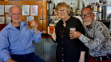 Clunes locals Richard Gilbert, Tess Brady, Hugh Wayland toast their new book A Thirst for Gold, which launches as part of Clunes Booktown Festival this weekend. Picture supplied