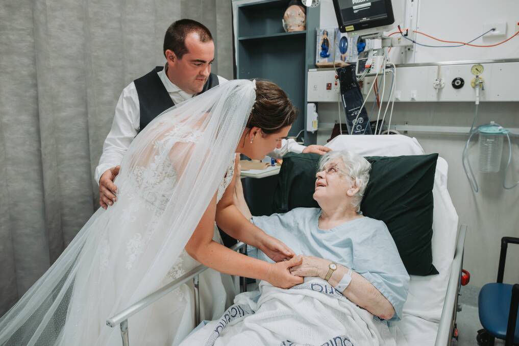 Alicia and Jacob Hinkley visit her grandma Dawn Drake in Warrnambool hospital on their wedding day. She had had a fall on the morning of the wedding and couldn't be there. Picture by Josh Beames
