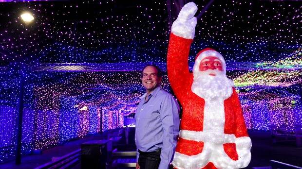 HEY, SANTA – Canberra's Dave Richards in front of the record-breaking 2014 light display he organised for SIDS and Kids ACT.   Photo: Melissa Adams
