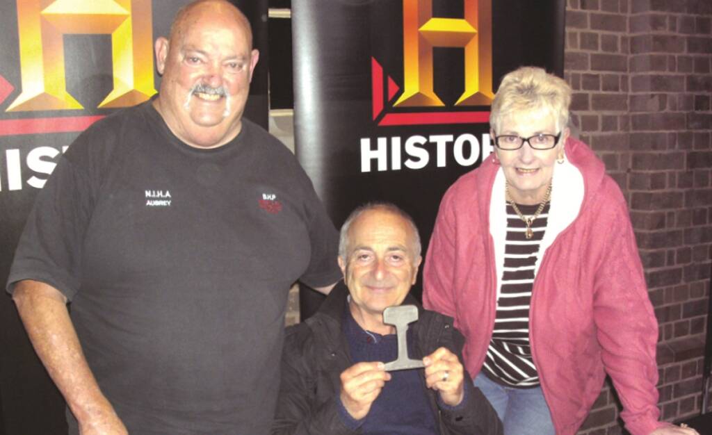 BIG DAY– Aubrey Brooks and his wife Peggy with  British history presenter Tony Robinson,  holding a piece of  BHP 1915 rail.