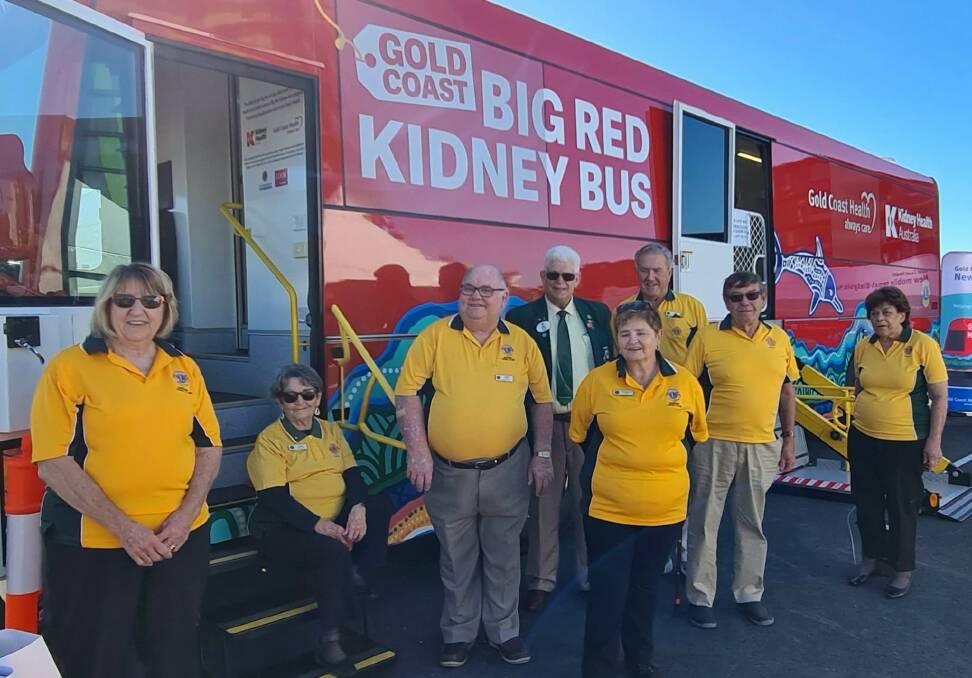 Members of Robina Lions Club and Lions district governor Ian Bruning (fourth from left) with the Big Red Kidney Bus.