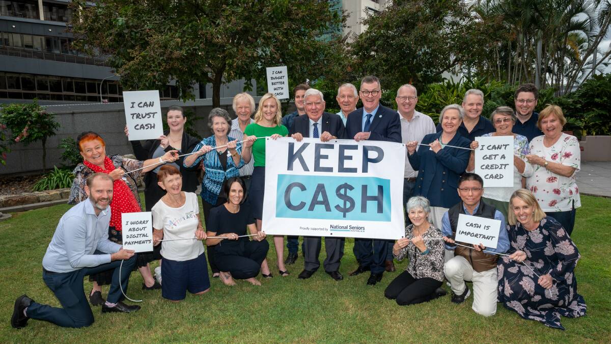 Staff, volunteers and members of National Seniors Australia promote the Keep Cash Campaign. 